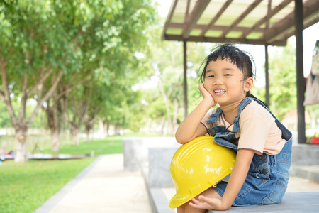 kid engineer look so tried after inspected her work in green garden building siteの写真素材