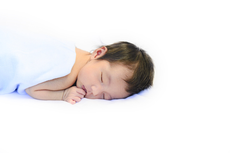 Cute new born baby sleeping on white cotton blanketの写真素材