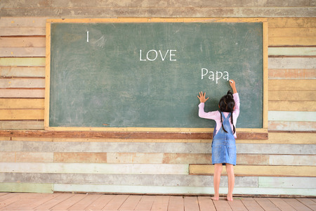 Kid write I love papa font on old green chalkboardの写真素材