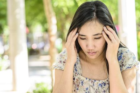 Asian woman on stress pose; serious and worry mood; Headache poseの写真素材