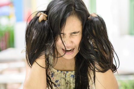Asian woman on stress pose; serious and worry moodの写真素材