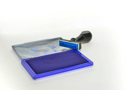 classic rubber stamp with opened blue ink pad isolatedの写真素材