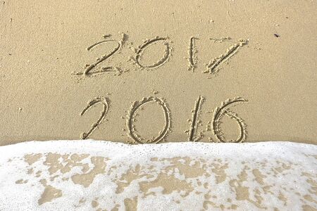 Good bye 2016 hello 2017. inscription written in the beach sand. New Year 2017 is coming concept on...
