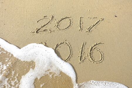 Good bye 2016 hello 2017. inscription written in the beach sand. New Year 2017 is coming concept on the sea beachの写真素材