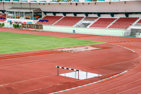 Outdoor red running track in stadium. field run in stadium background.の写真素材