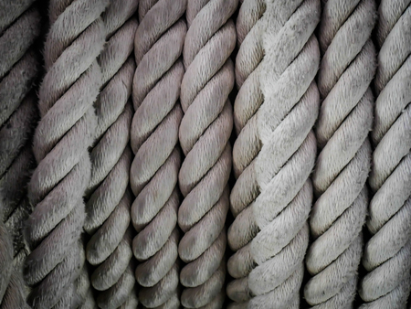 Close-up of an old frayed boat rope as background, Spiral of rope, Coiled rope on boats deck.のeditorial素材