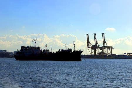 Silhouette, cargo ships, oil ships dock at the port. Economy cargo from around the worldの写真素材