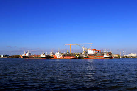 In the evening, cargo ships, oil ships dock at the port. Economy cargo from around the world