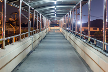 Walkway on the bridge at night, Thailand.の写真素材