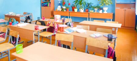 education, elementary school, teaching elementary school with desks and blackboards, open books and an interactive whiteboard. concept time to school, September 1の写真素材
