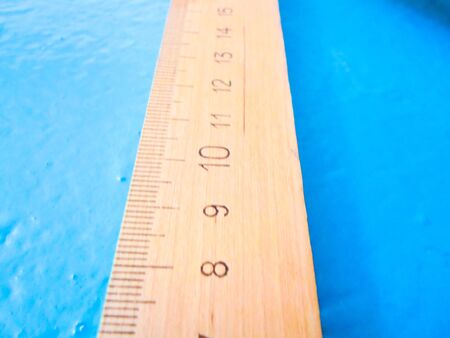 wooden ruler on a blue background. school suppliesの写真素材