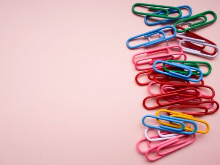 multicolored paperclips on a pink backgroundの写真素材