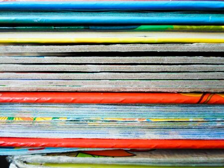 Books with colorful covers lined up on a bookshelf. Bright abstract background. back to school....
