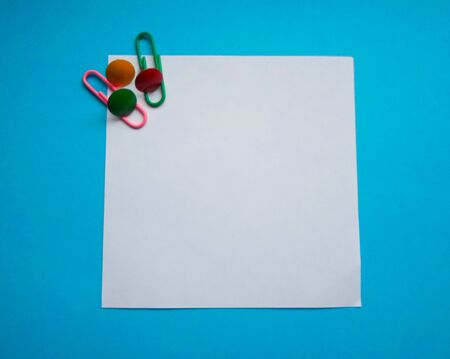 Two colored papers with blue and white flowers. White and blue paper in the middle of the horizontal...