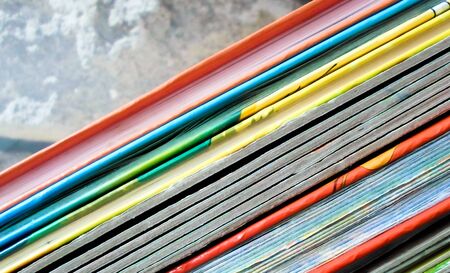 Books with colorful covers lined up on a bookshelf. Bright abstract background. back to school. colorful book bindingの写真素材