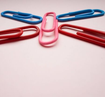 multicolored paperclips on a pink backgroundの写真素材