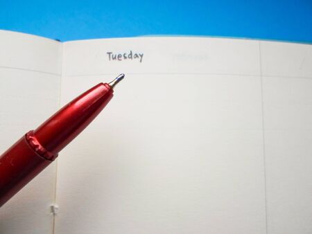 red pen on a white notebookの写真素材