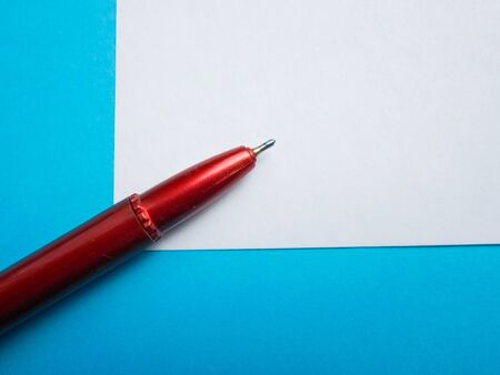 red pen on a white notebookの写真素材