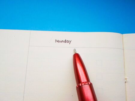 red pen on a white notebookの写真素材