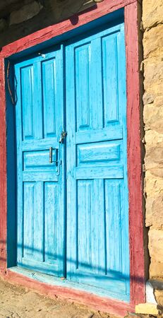 old blue door in an abandoned house. architecture of an old buildingの写真素材
