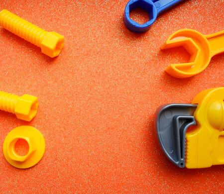 toy tools, wrench and others on an orange background. place for textの写真素材