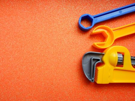 toy tools, wrench and others on an orange background. place for textの写真素材