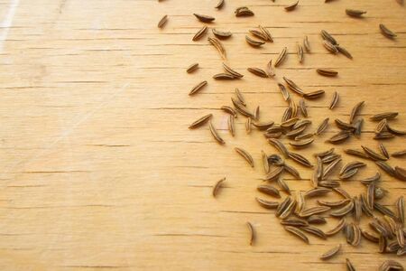 a lot of caraway seeds on a wooden table. Healthy lifestyle concept.の写真素材