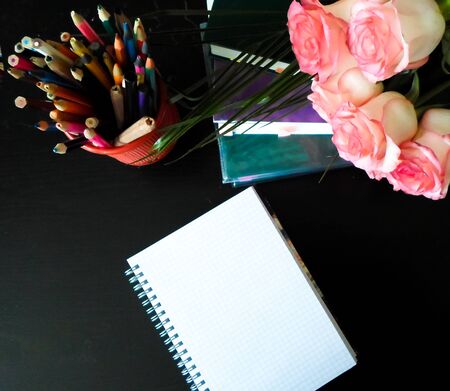 September 1 concept. Books, flowers, pencils on a black table. September 1 is the word in Russian. side viewの写真素材