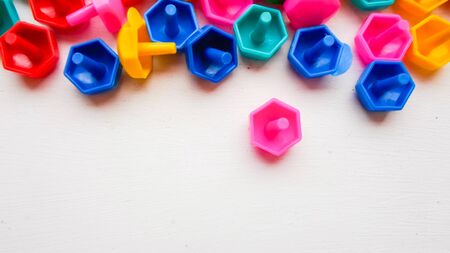 There are colored toys on the floor. Educational colorful toys. Children's toys frame on a wooden background.の写真素材