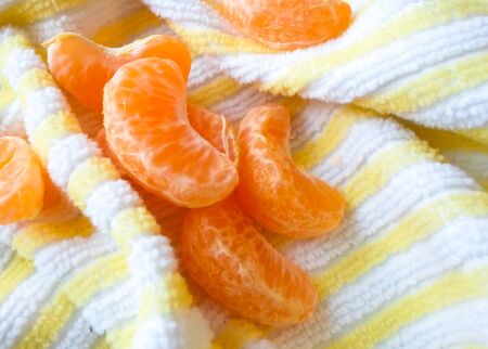 a lot of tangerine on a table with a napkin