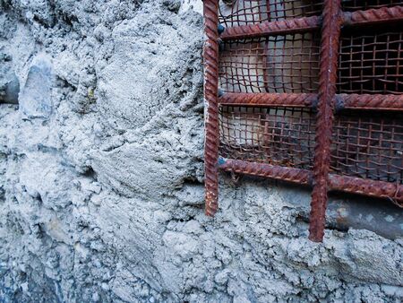 iron grate on a concrete wall. iron windows in prisonの写真素材