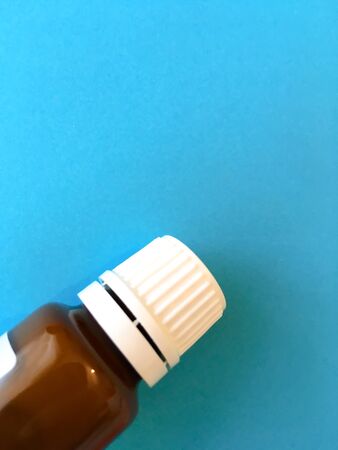 Bottle with liquid medicine. Transparent brown bottle with a cap.の写真素材