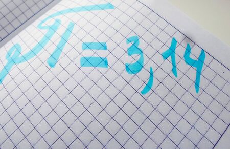 pi day - pi sign is written with a pen and marker for the holiday of March 14, on a white...
