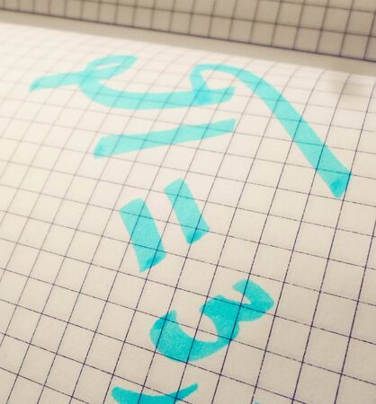 pi day - pi sign is written with a pen and marker for the holiday of March 14, on a white background, top view, copy space.の写真素材
