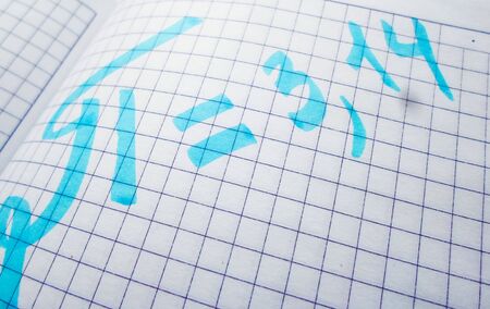 The number pi is written in a notebook with a pen or marker. Pi day number concept. pi is 3.14