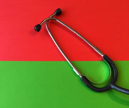 Top view stethoscope on green and red background. To check heart or health check concept.の写真素材
