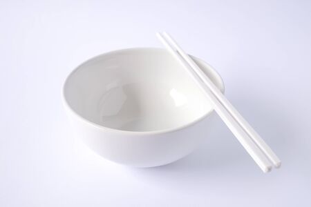 white bowl with chopsticks