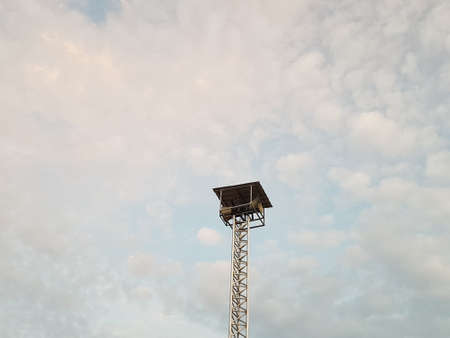 Speaker column broadcasting background evening sky orange blue white clouds