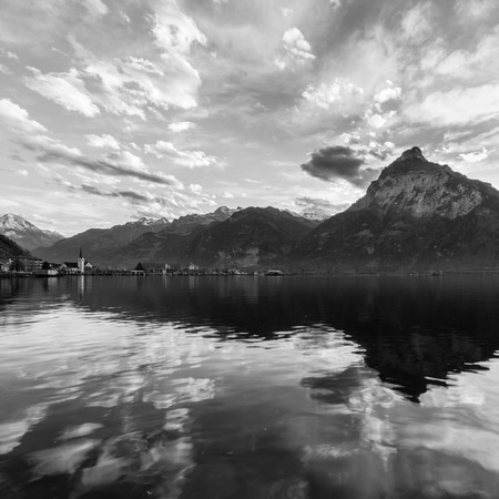 Mountain panorama. Clouds are reflected on the lake Blurred background. Black & whiteの写真素材