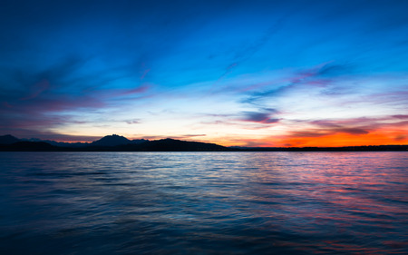 Dramatic sunset over the lake in the Swiss Alps. Canton Zug. In the background the mountains silhouettes. High Dynamic Range Imageの写真素材