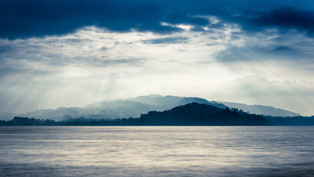 Grandiose panorama of Lake in Switzerland. In the background is a mountain landscape, sun rays play light and shadow. HDRIの写真素材