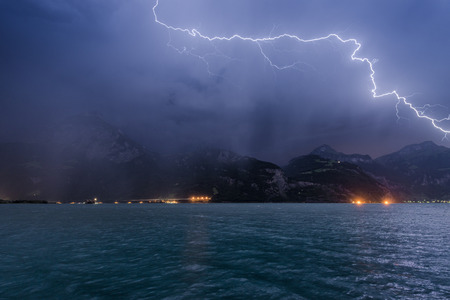 Lightning over the mountains and lake. long exposure.の写真素材