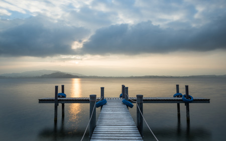 Wooden pier on the lake. Fog. Long exposure.の写真素材