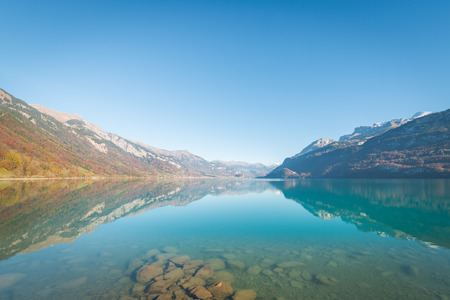 Large autumn landscape. Clear sky on a calm day. Swiss Alps and a lake near the city of Bern.の写真素材