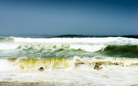 Storm surf waves in the ocean. Dark sky thunderstorms.の写真素材
