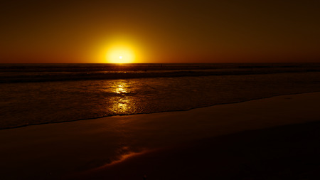 Coast Ocean late at night. Red tones of the setting sun.の写真素材