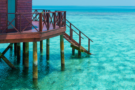Part of bungalow with stair descending into the sea. Turquoise color of the lagoon. Tropical island in the Indian Ocean. Luxury holiday.のeditorial素材