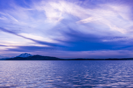 Luxury Sunset Lake. On a background the mountains. Play of light and shadow creates a gorgeous volume and distance.  Long exposure.の写真素材