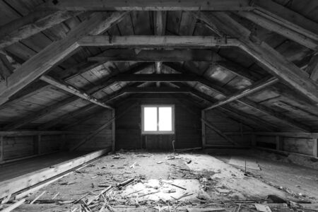 Dark loft,  window with bright light. Black and White.の写真素材