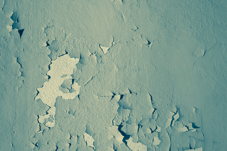 Natural background. Wall with a shabby and peeling paint and plaster. Contrast and volume. Turquoise.の写真素材